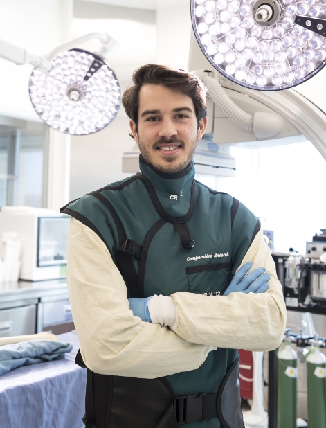 A Medventions Fellow poses with his arms crossed smiling in the operating room.